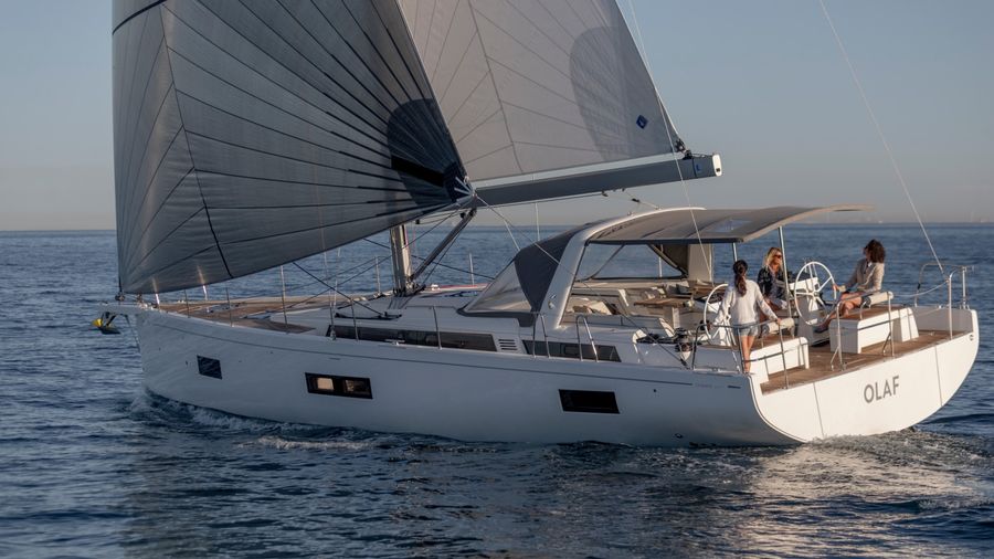Beneteau Oceanis 54 sailing at golden hour with crew in the cockpit
